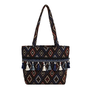 Ethnic woven tote bag with geometric patterns and blue tassels on white background