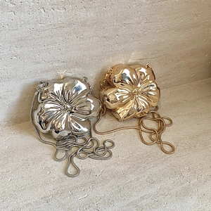 Artistic gold and silver flower shaped metal clutch bags with sleek snake chains