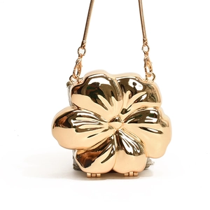 Elegant gold flower shaped evening clutch bag with metallic finish and long snake chain