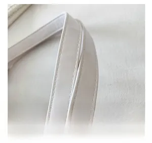 Detail of white PU leather tote bag handle featuring precise double-row stitching