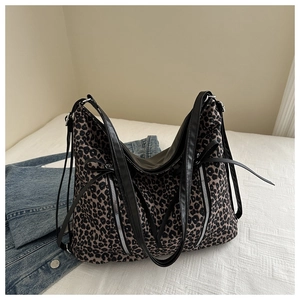 Dettaglio borsa tote leopardata con doppie cerniere argentate e manici in pelle