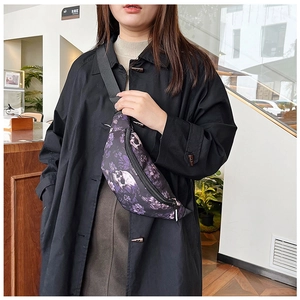 Close-up of gothic purple floral skull print chest bag with black adjustable strap