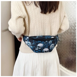 Rear view of a stylish nylon skull print waist bag worn over a beige cable knit sweater