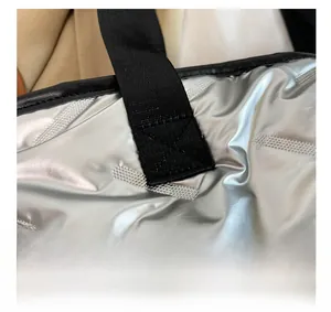 Close-up of durable reinforced stitching on metallic silver waterproof fabric bag