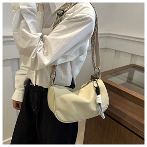 Detail of off-white canvas crossbody bag with geometric woven strap and rope knot decor