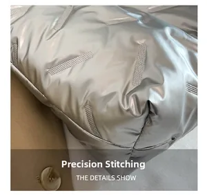 Detailed close-up of precision stitching on a quilted silver tote bag with metallic finish