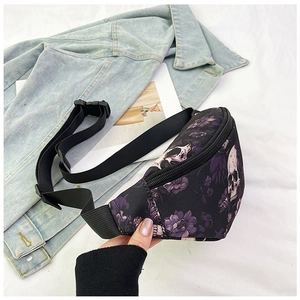 Detailed view of skull and floral print on canvas chest bag with adjustable nylon strap