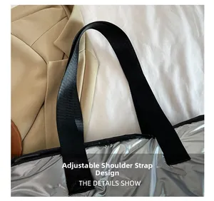 Detail shot of the adjustable black woven shoulder strap on a silver quilted tote bag