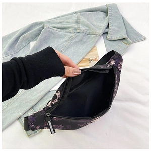 Detail of waist bag showing black inner lining and zipper closure with puller