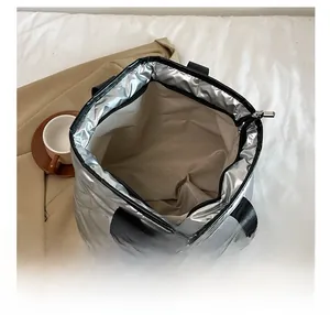 Internal view of the silver tote bag featuring insulated aluminum foil lining and zipper