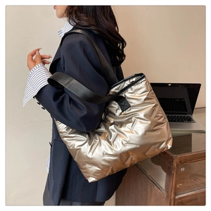 Quilted tote bag with champagne gold metallic finish and black wide fabric strap