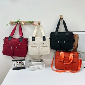 Waterproof nylon tote bags in four colors with multiple zipper pockets for women