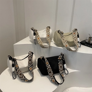 Chic Boston bags with wide woven straps in black, white, and khaki on minimalist stairs