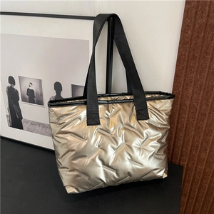Champagne gold quilted tote bag with black strap handles and large capacity design