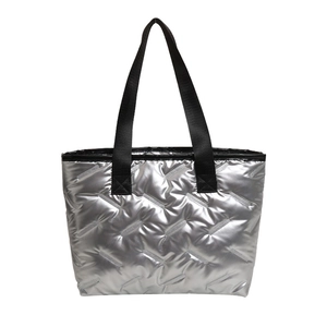 Silver quilted tote bag with black straps and metallic finish for 2025 fashion