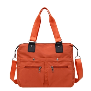 Waterproof orange nylon tote bag with multiple pockets and adjustable shoulder strap