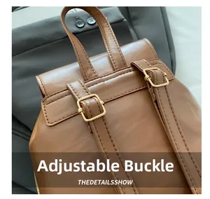 Macro detail of adjustable golden buckle and stitching on vintage brown leather backpack