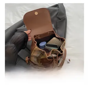 Interior view of large capacity vintage plaid backpack showing storage for daily essentials