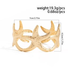 Macro detail of golden starfish upper arm cuff bracelet with weight and size specifications