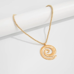 Detail of golden spiral shell pendant on thick rope chain necklace with radial texture