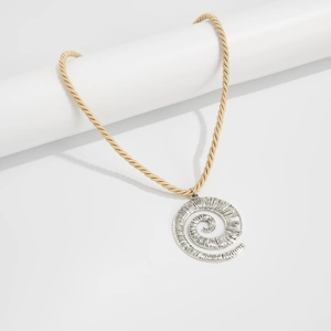 Detailed view of the gold twisted rope chain and large silver spiral pendant