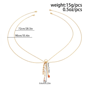 Detailed view of layered gold body chain with starfish, shell, and bead charms
