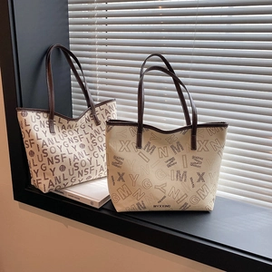 Large letter print tote bags in beige and apricot with brown leather handles