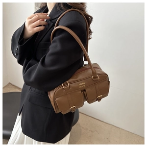 Detailed view of brown retro leather bag with double front buckle pockets by AKOBIA