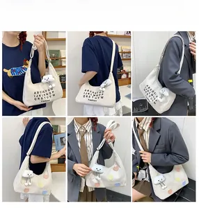 Canvas hobo tote bags with alphabet print and colorful hearts showing model styling