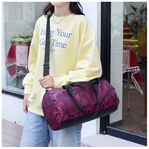 Detailed view of the large capacity purple camo duffel bag carried by a model