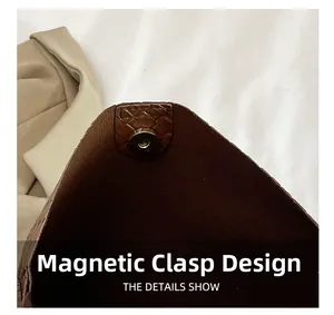 Detail view of the magnetic snap closure and embossed leather texture of the tote bag