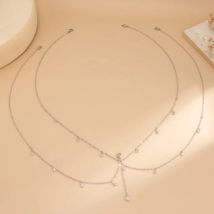 Detail of silver layered body chain with lobster clasp and sparkling rhinestone pendants