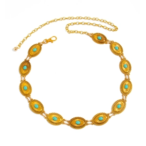 Vintage gold metal waist chain with geometric turquoise inlays on a white background