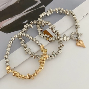 Detail view of irregular CCB beads bracelet set featuring heart pendant and metallic texture