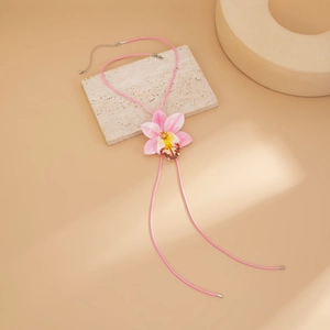 Close-up of pink gradient orchid pendant with pink cord necklace and metal clasp