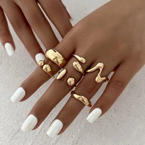 Irregular liquid gold ring set with minimalist aesthetic and molten metal texture