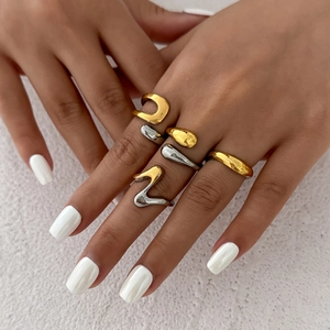 Minimalist liquid metal droplet rings in gold and silver finish on hands