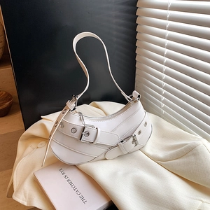 White crescent baguette bag with decorative silver buckle straps and Y2K motor style detail