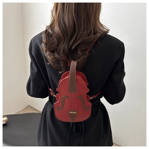 Detailed back view of a red PU leather violin-shaped backpack worn by a model