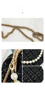 Detail of tweed shell bag with gold chain strap, metal lock, and white pearl accents