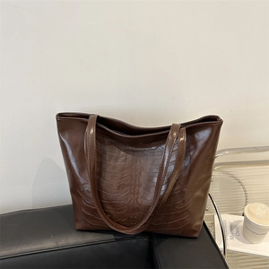 Brown vintage tote bag with unique skeletal rib cage embossed design in faux leather