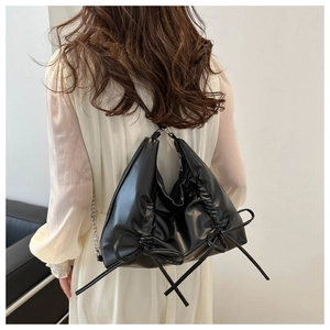 Black pleated faux leather shoulder bag with drawstring bow and metal chain strap