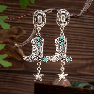 Detail of vintage silver cowboy boot earrings with turquoise stones and star charms