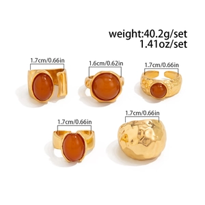 Detailed close-up of 5-piece gold alloy ring set with orange acrylic stone and hammer texture