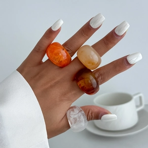 Colorful chunky resin rings set with marble patterns and translucent amber finish