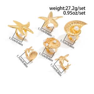 Detailed view of 6-piece gold ocean ring set with starfish, shells and faux pearls