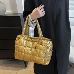 Détail du sac matelassé doré métallisé avec mini pochette assortie et coutures soignées