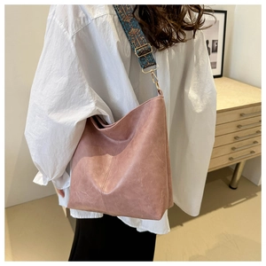 Detail of vintage pink tote bag with colorful ethnic embroidered wide shoulder strap