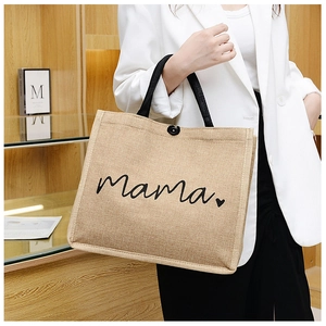 Detail of a large jute tote bag with Mama heart print and black woven handles