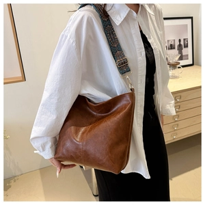 Retro brown PU leather crescent hobo bag featuring a vintage ethnic pattern wide strap